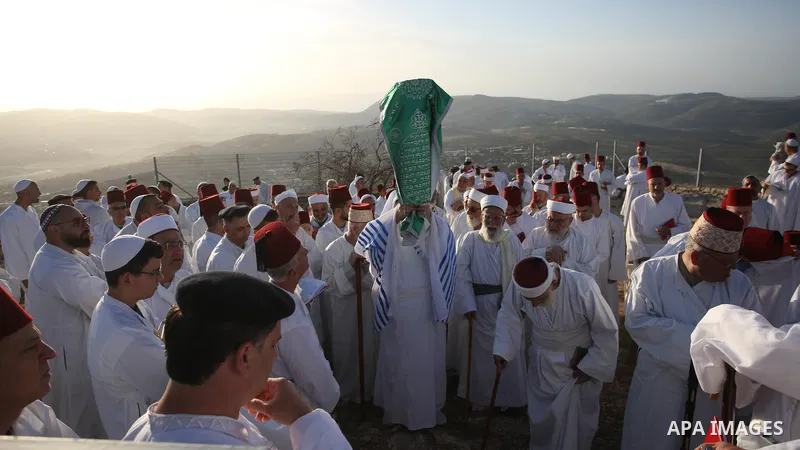 Members of the Samaritan community pray at sunrise during a religious service marking the end of their Passover holiday atop Mount Gerizim, above the West Bank city of Nablus, 02 May 2021. According to tradition, the Sam...