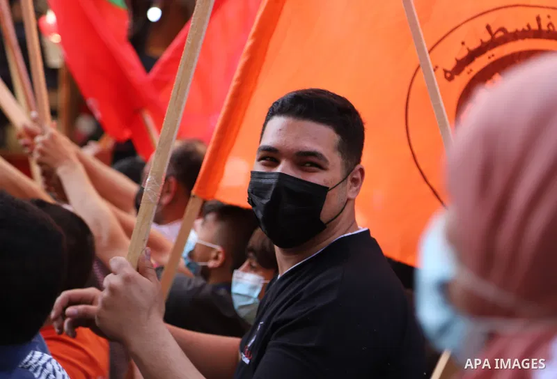 Palestinian supporters of the Popular Front for the Liberation of Palestine, and National Initiative party, take part in a protest against postponement of the Palestinian parliamentary and presidential elections and supp...