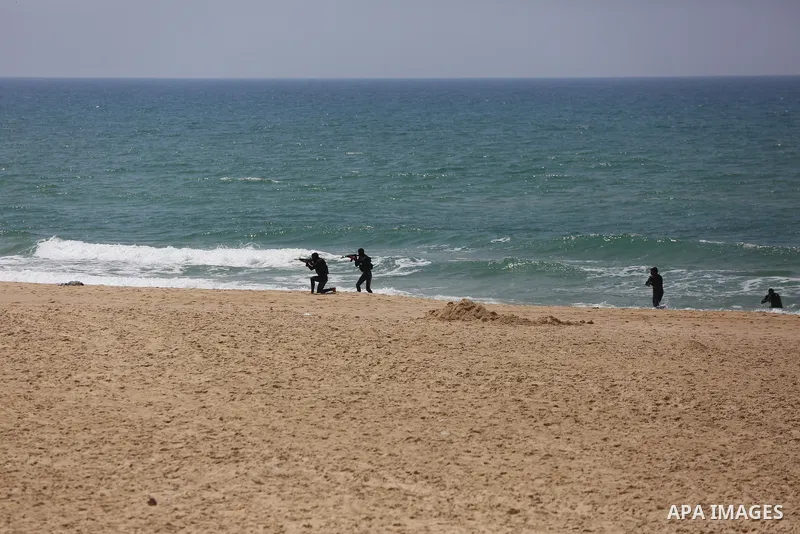 Members of al-Mujahideen brigades, the military wing of al-Mujahideen movement, take part in a military drill, marking the 20th anniversary of the founding of its launch, in Gaza city, on April 24, 2021. The attack maneu...
