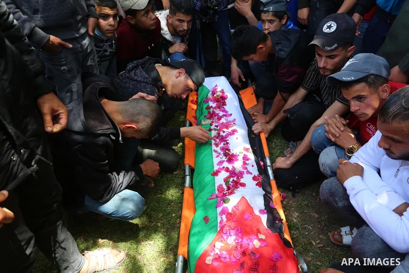 Relatives of the Palestinian Yousef Abu Jazar, mourn during his funeral, in Rafah in the southern of Gaza strip, on April 25, 2021. On Thursday, the Israeli occupation authorities delivered the body of the Palestinian ch...