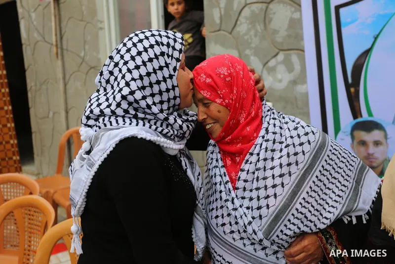 Freed Palestinian Samar Abu Daher, 37, is welcomed by relatives upon her release from Israeli Jails at her home in the Khan Younis in the southern Gaza Strip on April 27, 2021. Photo by Ashraf Amra