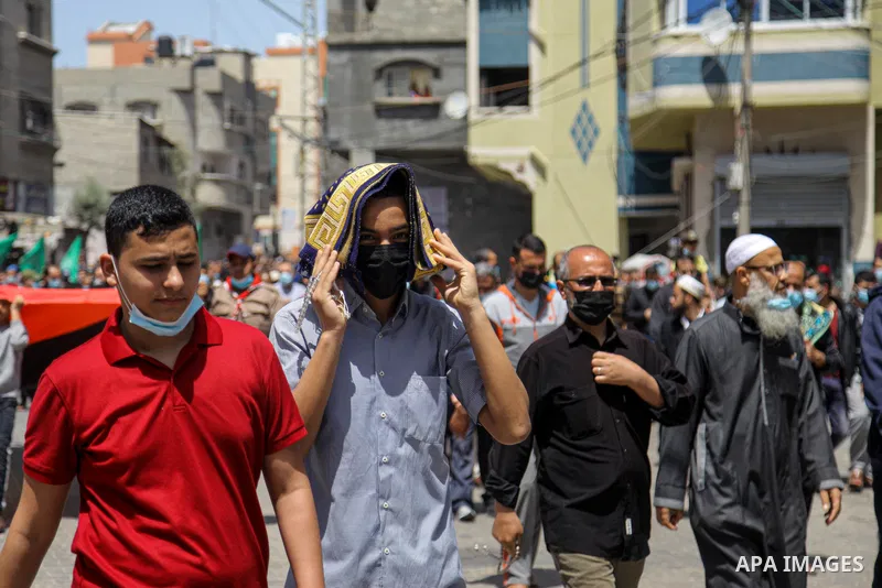 Palestinian supporters of Hamas movement demonstrate against postponement of the Palestinian parliamentary and presidential elections, calling for holding elections on planned date in Jabalia in the nothern Gaza Strip on...