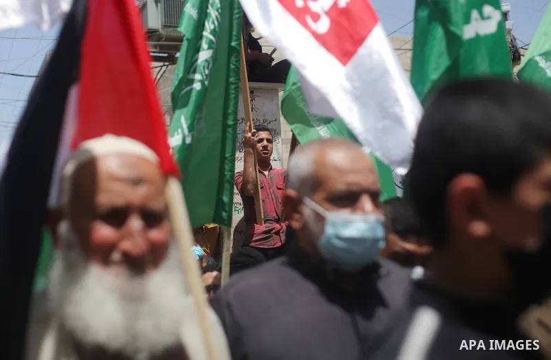 Supporters of the Hamas movement take part in a rally against the decision of the Palestinian authorities president to delay the legislative and presidential polls scheduled for May 22 and July 31, respectively, in Gaza...