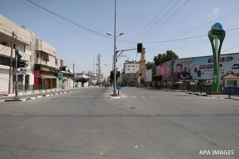 Paestinians walk at a deserted street is pictured during a lockdown following the outbreak of the coronavirus disease (COVID-19), in Gaza city, on April 23, 2021. Ahead of Ramadan, the authorities in Gaza Strip declared...