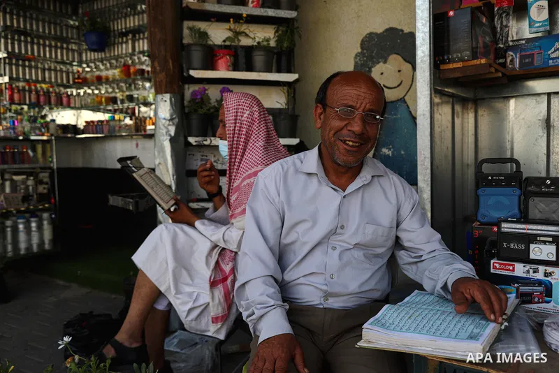 A Palestinian Muslim reads holy Quran during the Muslim holy month of Ramadan, in Gaza City on April 22, 2021 amid the coronavirus disease (COVID-19) outbreak. Palestinians welcomed the Muslim fasting month of Ramadan un...