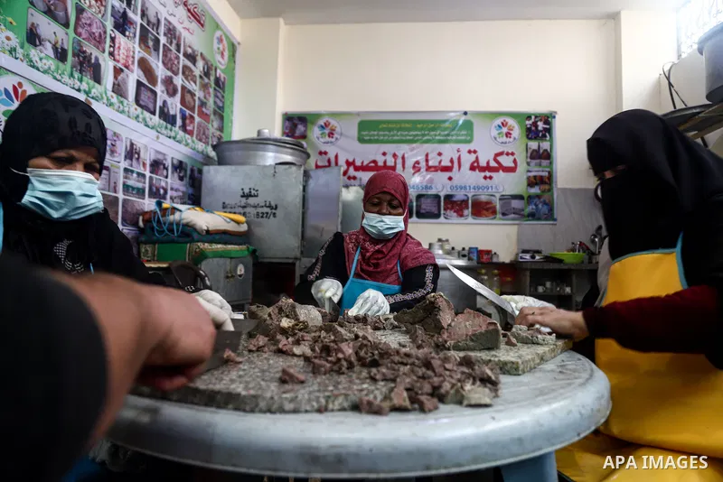 Palestinian volunteers prepare food before distribute it for Poor families during the holy fasting cof Ramadan, in Nuseirat in the center of Gaza Strip on April 21 , 2021. There has been a significant drop in the amount...