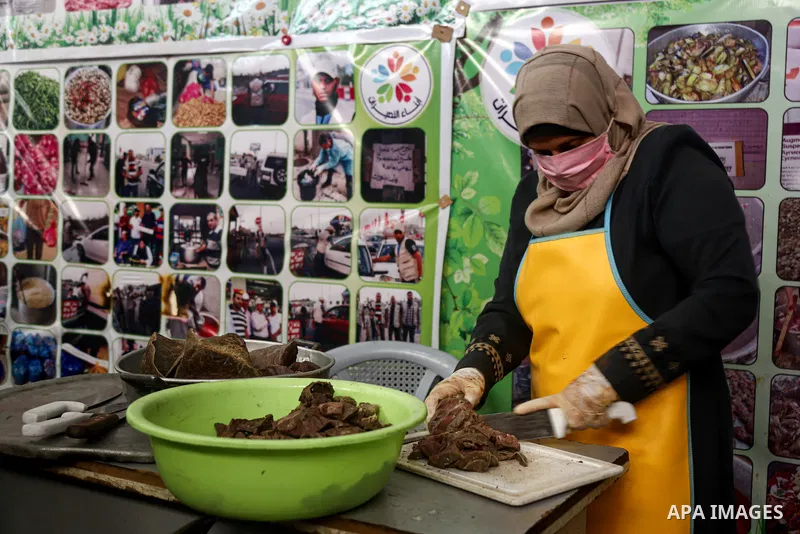 Palestinian volunteers prepare food before distribute it for Poor families during the holy fasting cof Ramadan, in Nuseirat in the center of Gaza Strip on April 21 , 2021. There has been a significant drop in the amount...