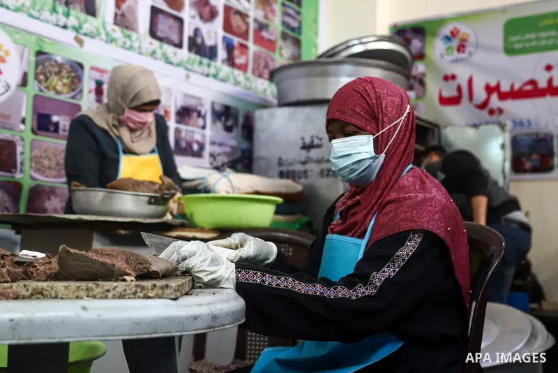 Palestinian volunteers prepare food before distribute it for Poor families during the holy fasting cof Ramadan, in Nuseirat in the center of Gaza Strip on April 21 , 2021. There has been a significant drop in the amount...