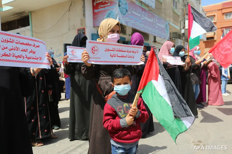 Supporters of the Popular Front for the Liberation of Palestine, take part in a protest to demand the payment of social affairs allowances, in front of the Directorate of Social Affairs, in Deir Al-Balah camp in the cent...