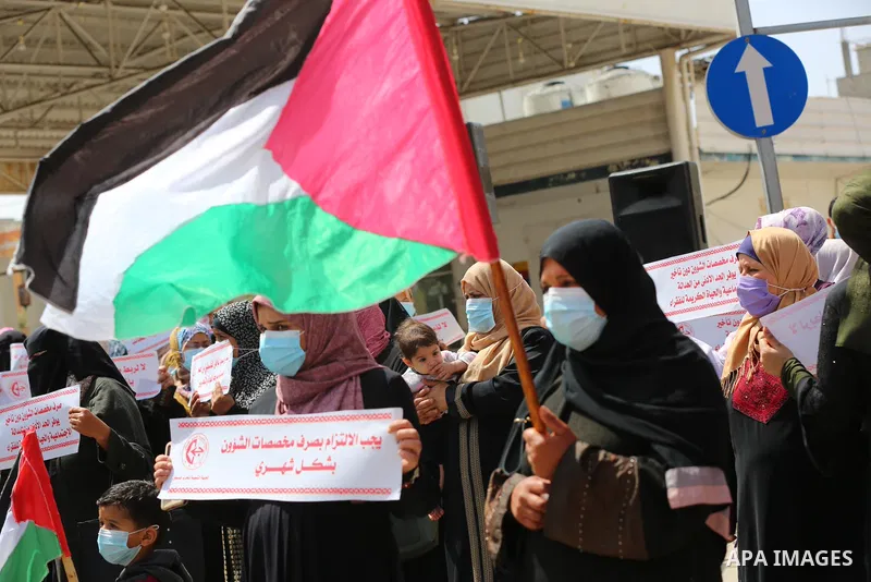Supporters of the Popular Front for the Liberation of Palestine, take part in a protest to demand the payment of social affairs allowances, in front of the Directorate of Social Affairs, in Deir Al-Balah camp in the cent...
