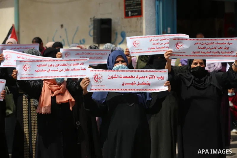 Supporters of the Popular Front for the Liberation of Palestine, take part in a protest to demand the payment of social affairs allowances, in front of the Directorate of Social Affairs, in Deir Al-Balah camp in the cent...