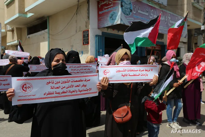 Supporters of the Popular Front for the Liberation of Palestine, take part in a protest to demand the payment of social affairs allowances, in front of the Directorate of Social Affairs, in Deir Al-Balah camp in the cent...
