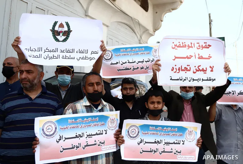 Palestinian PA employees take part during a protest against early forced retirement, in front of Palestine TV. headquarter, in Gaza City on April 21, 2021. Palestinian Prime Minister Mohammad Shtayyeh previously announce...