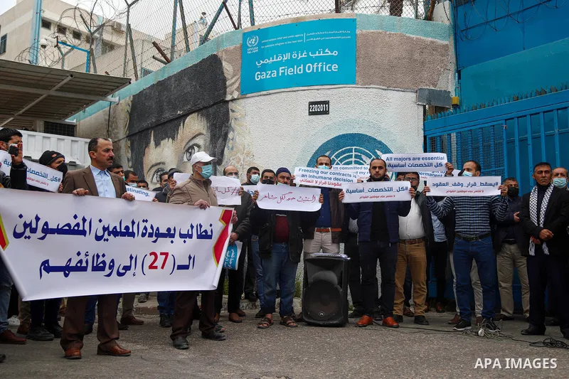 Palestinian teachers take part in a protest demanding their rights in front of the headquarters United Nations Relief and Works Agency (UNRWA), in Gaza City on April 11, 2021. The teachers in the United Nations Relief an...