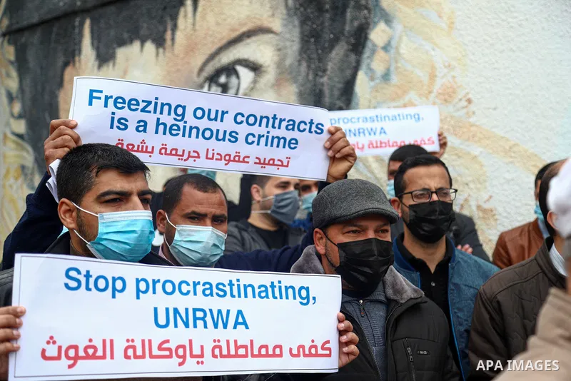 Palestinian teachers take part in a protest demanding their rights in front of the headquarters United Nations Relief and Works Agency (UNRWA), in Gaza City on April 11, 2021. The teachers in the United Nations Relief an...