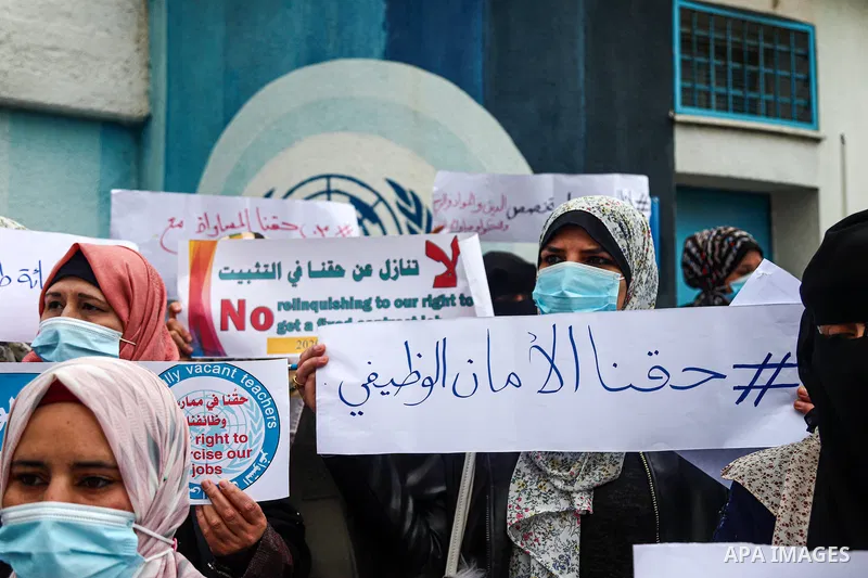 Palestinian teachers take part in a protest demanding their rights in front of the headquarters United Nations Relief and Works Agency (UNRWA), in Gaza City on April 11, 2021. The teachers in the United Nations Relief an...