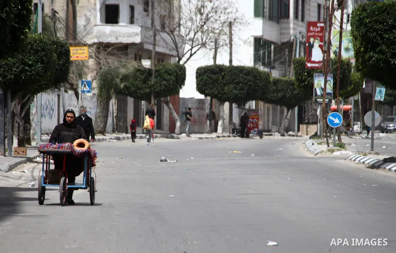 Paestinians walk at a deserted street is pictured during a lockdown following the outbreak of the coronavirus disease (COVID-19), in Gaza city, on April 10, 2021. New coronavirus cases were down today in the West Bank an...