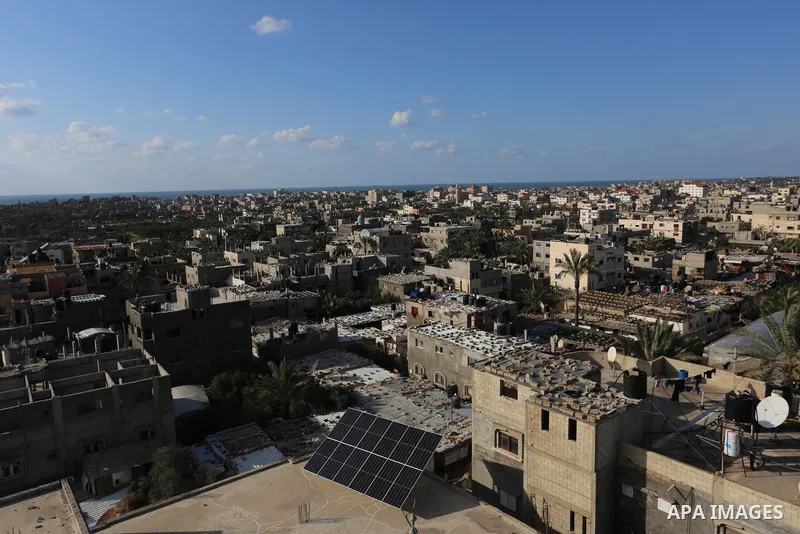 A picture taken with a drone shows Palestinian houses and buildings at Dair Al Balah refugee camp in the Central Gaza Strip on April 8, 2021. - The United States said it was restoring assistance to the Palestinians sever...