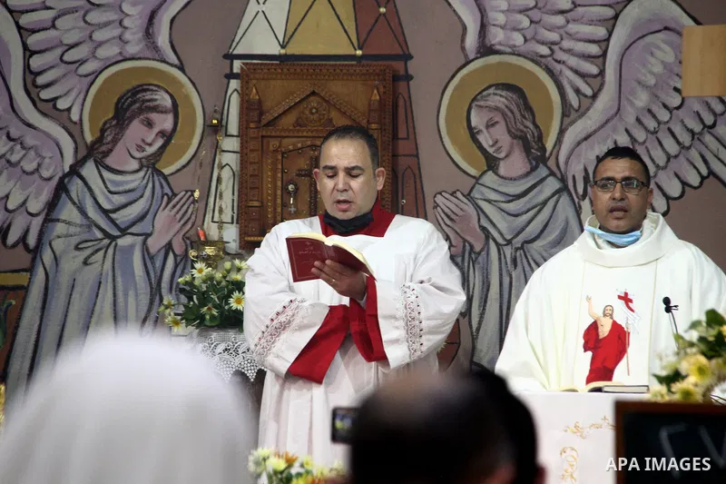 Palestinian Christians attend an Easter vigil mass, amid the coronavirus disease (COVID-19) outbreak at a church of Deir Latin, in Gaza City, on April 4, 2021. Easter Vigil, also called the Paschal Vigil or the Great Vig...