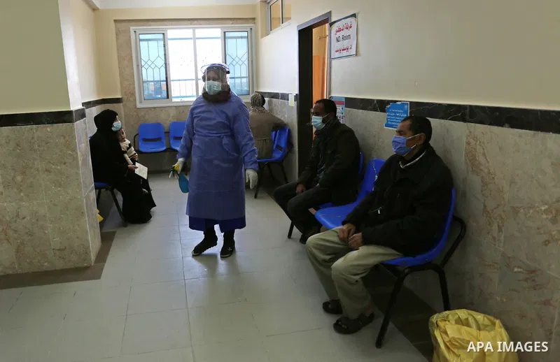 UNRWA employees wear face masks as the provide services, amid the spread of the Coronavirus COVID-19, in a UN clinic in Deir El-Balah, in the center of the Gaza Strip, on April 3, 2021. President Mahmoud Abbas today issu...