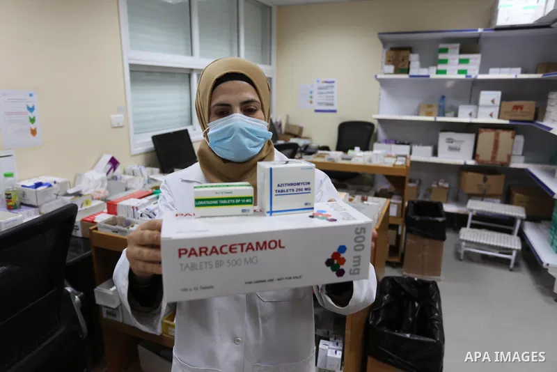 UNRWA employees wear face masks as the provide services, amid the spread of the Coronavirus COVID-19, in a UN clinic in Deir El-Balah, in the center of the Gaza Strip, on April 3, 2021. President Mahmoud Abbas today issu...