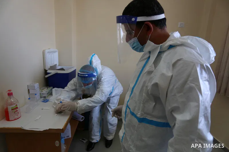 UNRWA employees wear face masks as the provide services, amid the spread of the Coronavirus COVID-19, in a UN clinic in Deir El-Balah, in the center of the Gaza Strip, on April 3, 2021. President Mahmoud Abbas today issu...