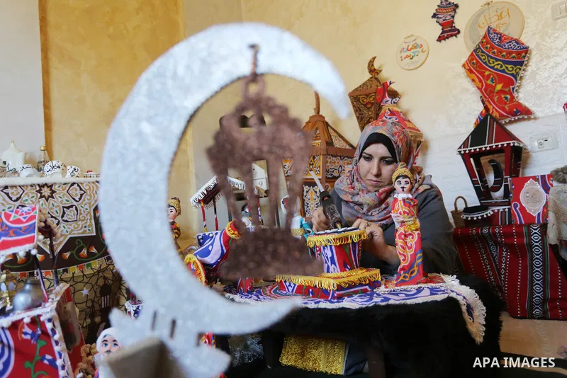 Palestinian Hanan al-Madhoun, 37, builds a traditional lantern, called a "fanous" used as a decoration to celebrate the start of the Muslim holy month of Ramadan, amid the coronavirus disease (COVID-19), at her home in G...