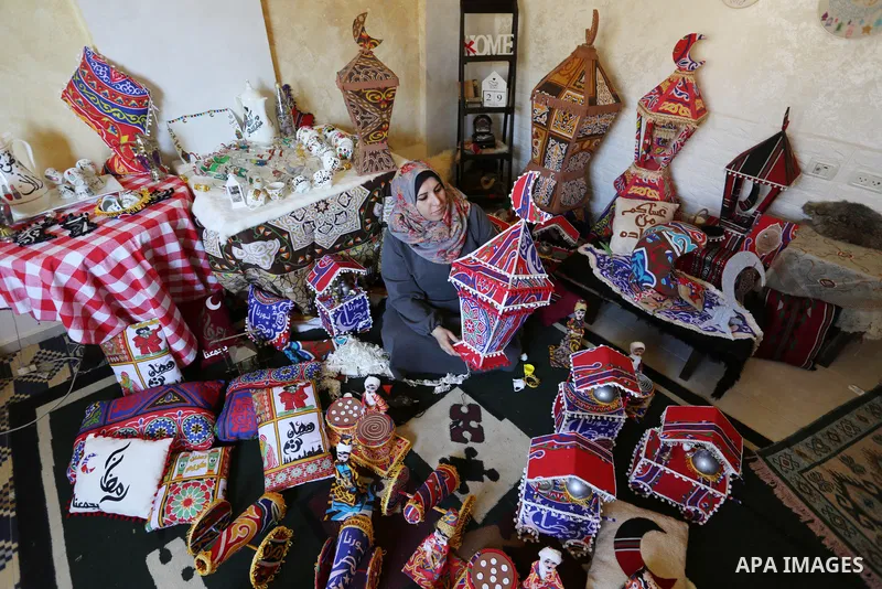 Palestinian Hanan al-Madhoun, 37, builds a traditional lantern, called a "fanous" used as a decoration to celebrate the start of the Muslim holy month of Ramadan, amid the coronavirus disease (COVID-19), at her home in G...