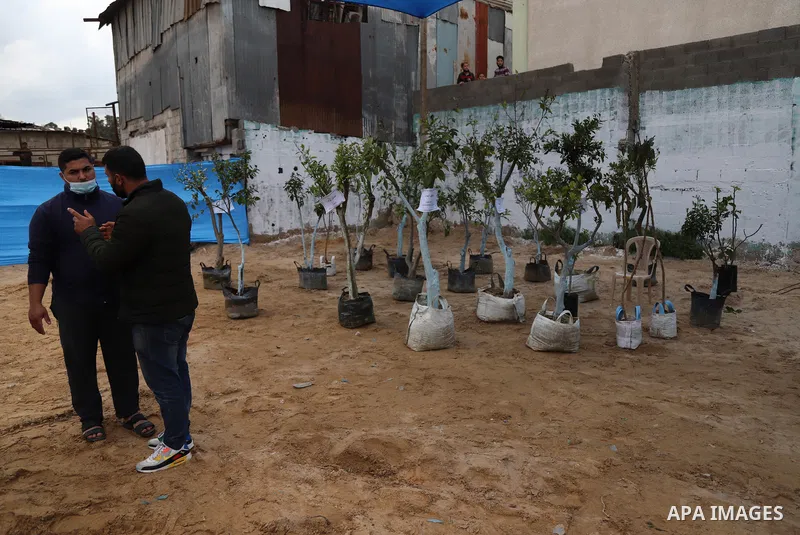 Palestinians attend the opening of the "Rabie My Country" bazaar for saplings and flowers on the 45th anniversary of Land Day, in Gaza City on March 30, 2021. Palestinians every year mark Land Day on March 30 commemorati...