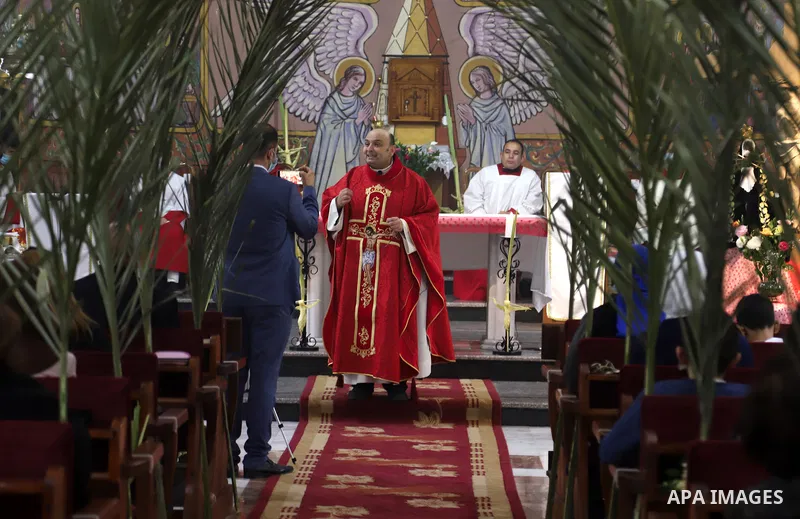 Palestinian Christians attend a mass on a Palm Sunday, amid the coronavirus disease (COVID-19) outbreak at a church of Deir Latin, in Gaza City, on March 28, 2021. Palm Sunday is a Christian moveable feast that falls on...