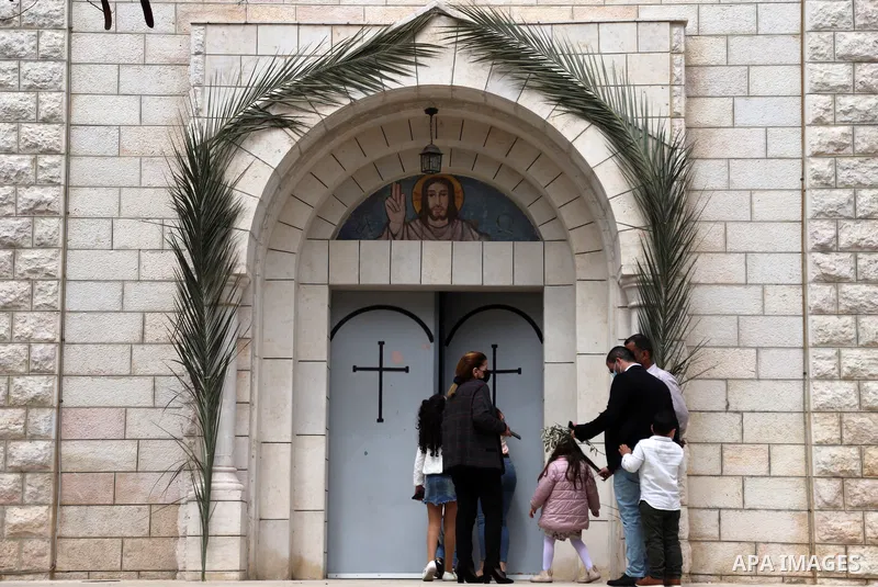 Palestinian Christians attend a mass on a Palm Sunday, amid the coronavirus disease (COVID-19) outbreak at a church of Deir Latin, in Gaza City, on March 28, 2021. Palm Sunday is a Christian moveable feast that falls on...