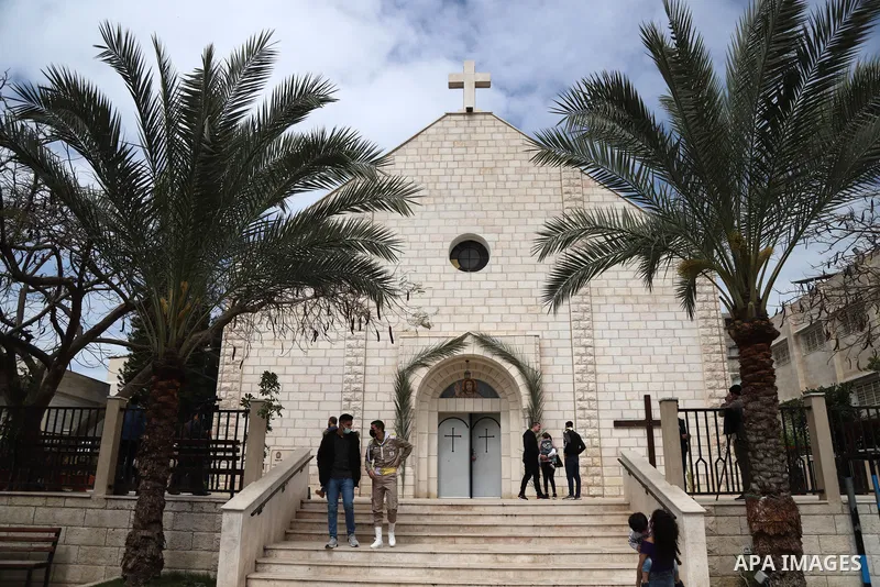 Palestinian Christians attend a mass on a Palm Sunday, amid the coronavirus disease (COVID-19) outbreak at a church of Deir Latin, in Gaza City, on March 28, 2021. Palm Sunday is a Christian moveable feast that falls on...