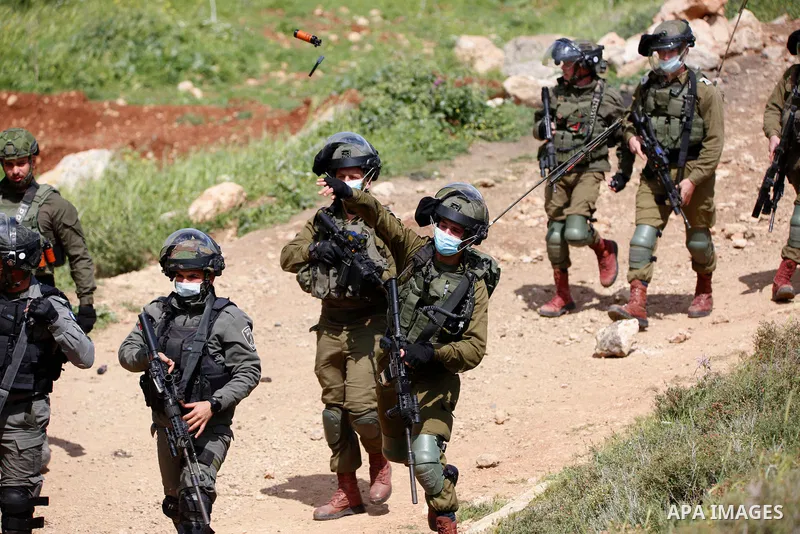 Israeli forces take position during a protest against the establishment of Israeli outposts in Palestinian lands, in Beit Dajan in the Israeli-occupied West Bank March 26, 2021. Israeli forces today cracked down on an an...