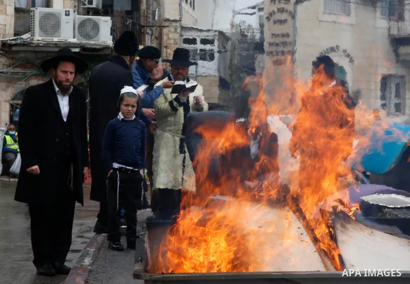 Ultra-Orthodox Jewish men burn leaven ahead of the upcoming Jewish holiday of Passover as the country begins to emerge from coronavirus disease (COVID-19) pandemic closures due to its rapid vaccine roll-out, in the Mea S...