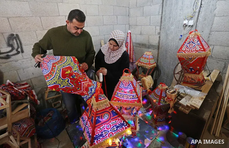 Palestinian Khaled Sweidan,44, and his wife Ghadeer Zindah,40, make lanterns for sale in their home in preparation for the Muslim holy month of Ramadan, amid the coronavirus disease (COVID-19), in Khan Younis in the sout...