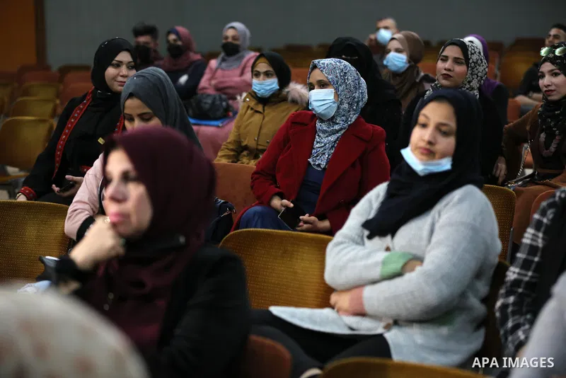 Palestinians wear protective face masks, amid the coronavirus disease (COVID-19), attend the operetta entitled "Gharib ya Bladi" on the anniversary of the Battle of Dignity and International Theater Day in Gaza City on M...