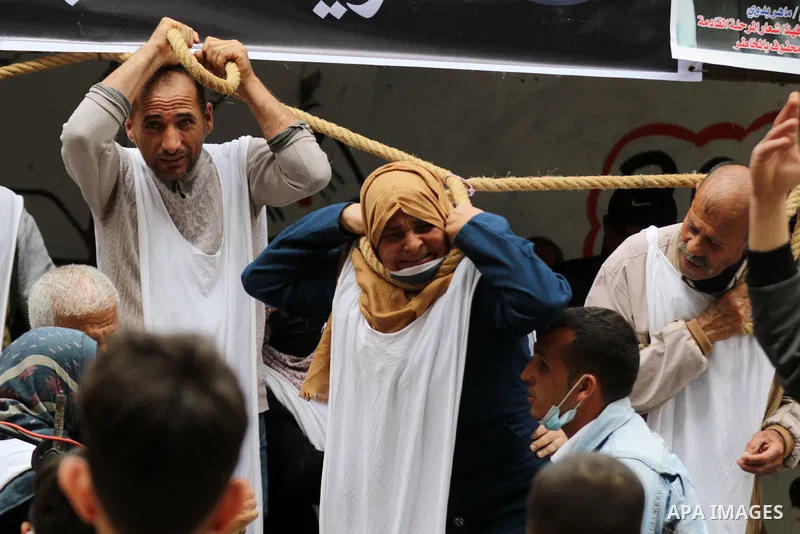 Families of Palestinian martyrs and wounded, take part in a protest tent against the Palestinian Authority's decision to cut their salaries for seven years, in Gaza city, on March 23, 2021. "The leaders agreed on the sol...