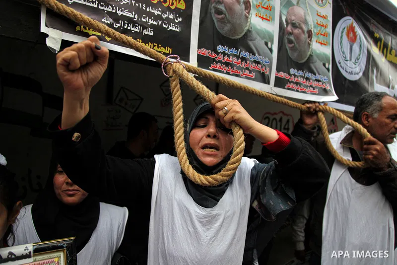 Families of Palestinian martyrs and wounded, take part in a protest tent against the Palestinian Authority's decision to cut their salaries for seven years, in Gaza city, on March 23, 2021. "The leaders agreed on the sol...