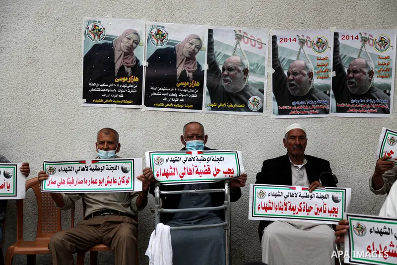 Families of Palestinian martyrs and wounded, take part in a protest tent against the Palestinian Authority's decision to cut their salaries for seven years, in Gaza city, on March 23, 2021. "The leaders agreed on the sol...