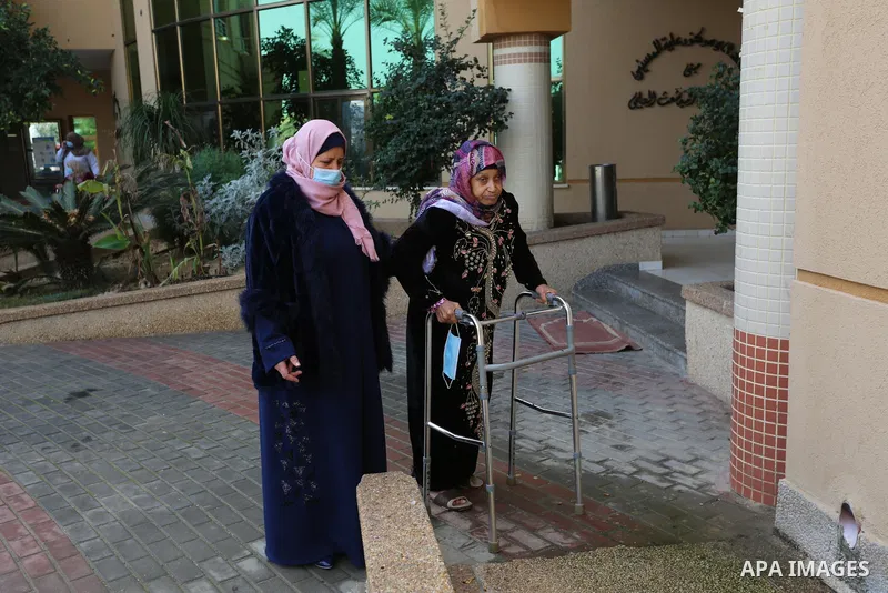 Palestinian elderly take part during a celebration on the occasion of Mother's Day, at el-Wafa elderly nursing home in Gaza city, on March 21, 2021. Mother's Day is a celebration honoring the mother of the family, as wel...