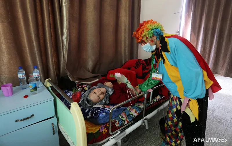 Palestinian elderly take part during a celebration on the occasion of Mother's Day, at el-Wafa elderly nursing home in Gaza city, on March 21, 2021. Mother's Day is a celebration honoring the mother of the family, as wel...