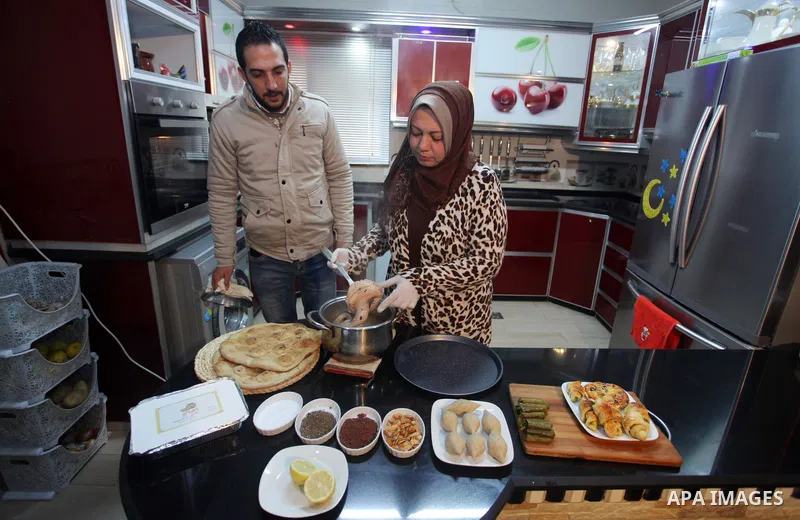 Palestinian chef, Lubna Rizk, cooks at her home, in Gaza city, on March 20, 2021. Rizk is the owner of my mother's food project, where she cooks traditional foods and sells them to customers. Mother's Day is a celebratio...