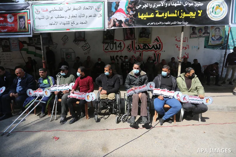 Palestinians take part in a protest take part in a portest on the Palestinian Wounded's Day, in Gaza city, on March 13, 2021. Al-Mezan Center for Human Rights said that more than (250,000) Palestinians were injured by th...