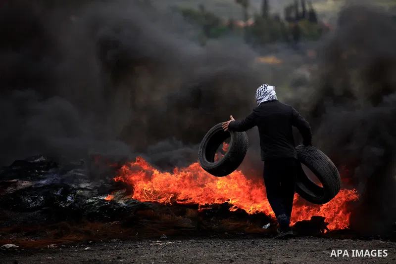 Palestinian protesters burn tires during clashes with Israel forces following a weekly demonstration against the expropriation of Palestinian land by Israel in the village of Kfar Qaddum, near the West Bank city of Nablu...