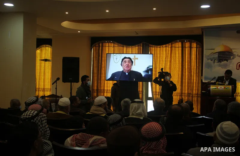 Supporters of the Islamic Jihad Movement in Palestine, watch while Manuel Muslim is a Christian cleric speaking via a video link during a popular conference on the anniversary of Israa and Mi'raj and Conquest of Jerusale...