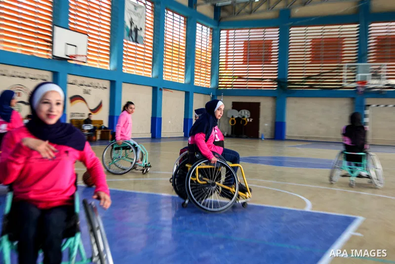 Palestinians women of special needs take part in a basketball training in a gymnasium, on the International Women's Day, on March 8, 2021. International Women's Day (IWD) is celebrated on 8 March around the world. It is...