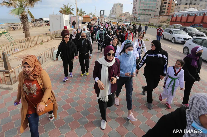 Palestinians take part in a walking sport on the International Women's Day, in Gaza city on March 8, 2021. International Women's Day (IWD) is celebrated on 8 March around the world. It is a focal point in the movement fo...