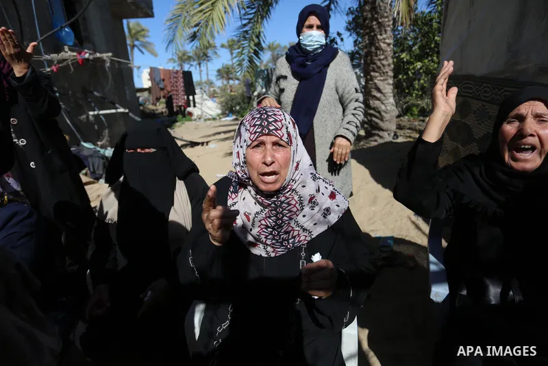Relatives of the three Palestinian fishermen, who were killed when their boat exploded off Gaza's coast in the Mediterranean Sea, mourn during their funeral in Khan Yunis in the southern Gaza Strip. Three Palestinian fis...