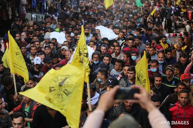 Palestinian mourners carry the body of the three Palestinian fishermen, who were killed when their boat exploded off Gaza's coast in the Mediterranean Sea, during their funeral in Khan Yunis in the southern Gaza Strip. T...