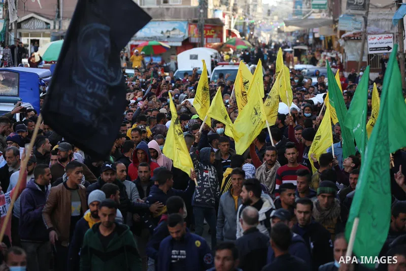 Palestinian mourners carry the body of the three Palestinian fishermen, who were killed when their boat exploded off Gaza's coast in the Mediterranean Sea, during their funeral in Khan Yunis in the southern Gaza Strip. T...